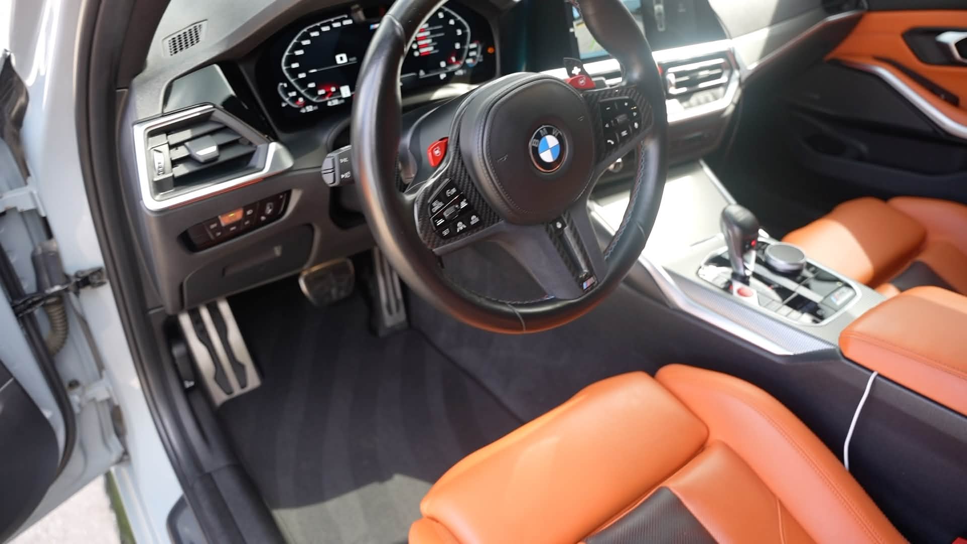 Clean BMW interior with orange leather seats and black dashboard
